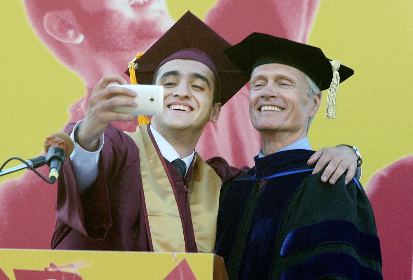 ASGCC President Davit Avagyan takes a seflie for Facebook with school Superintendent and President Dr. David Viar at the graduation of Glendale College on Wednesday, June 11, 2014.