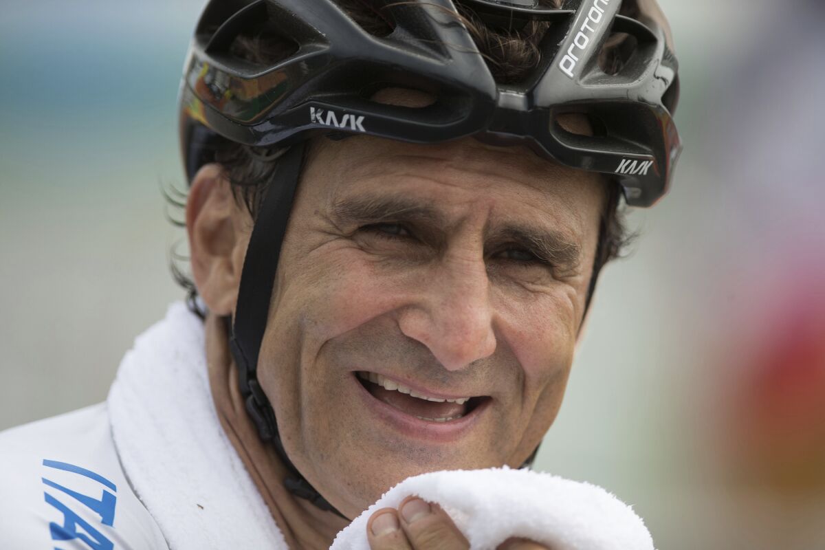 In this photo taken on Thursday, Sept. 15, 2016, Italy's Alessandro "Alex" Zanardi, smiles after winning the silver medal in the men's road race H5, during the 2016 Paralympics Games, in Rio de Janeiro, Brazil. Race car driver turned Paralympic champion Alex Zanardi has been seriously injured again. Police tell The Associated Press that Zanardi was transported by helicopter to a hospital in Siena following a road accident near the Tuscan town of Pienza during a national race for Paralympic athletes on handbikes. The 53-year-old Zanardi had both of his legs amputated following a horrific crash during a 2001 CART race in Germany. He was a two-time CART champion. (AP Photo/Mauro Pimentel)