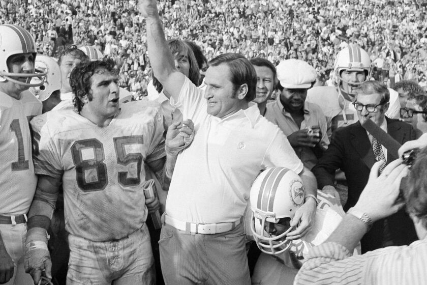 Dolphins Coach Don Shula celebrates as Miami defeats the Washington Redskins, 14-7, to complete their perfect 1972 season with a victory in Super Bowl VII.