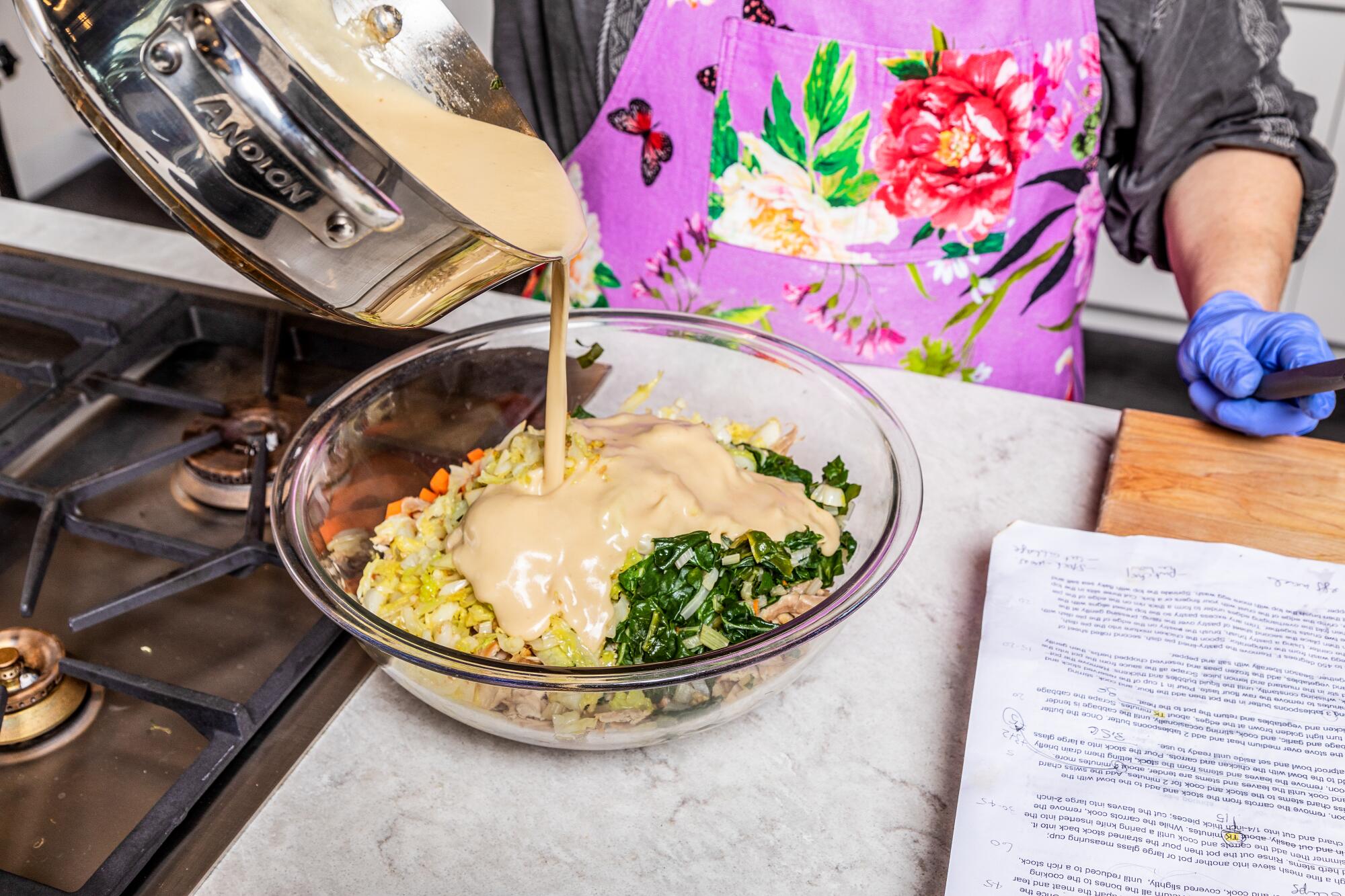 Roux is added to a bowl full of ingredients.