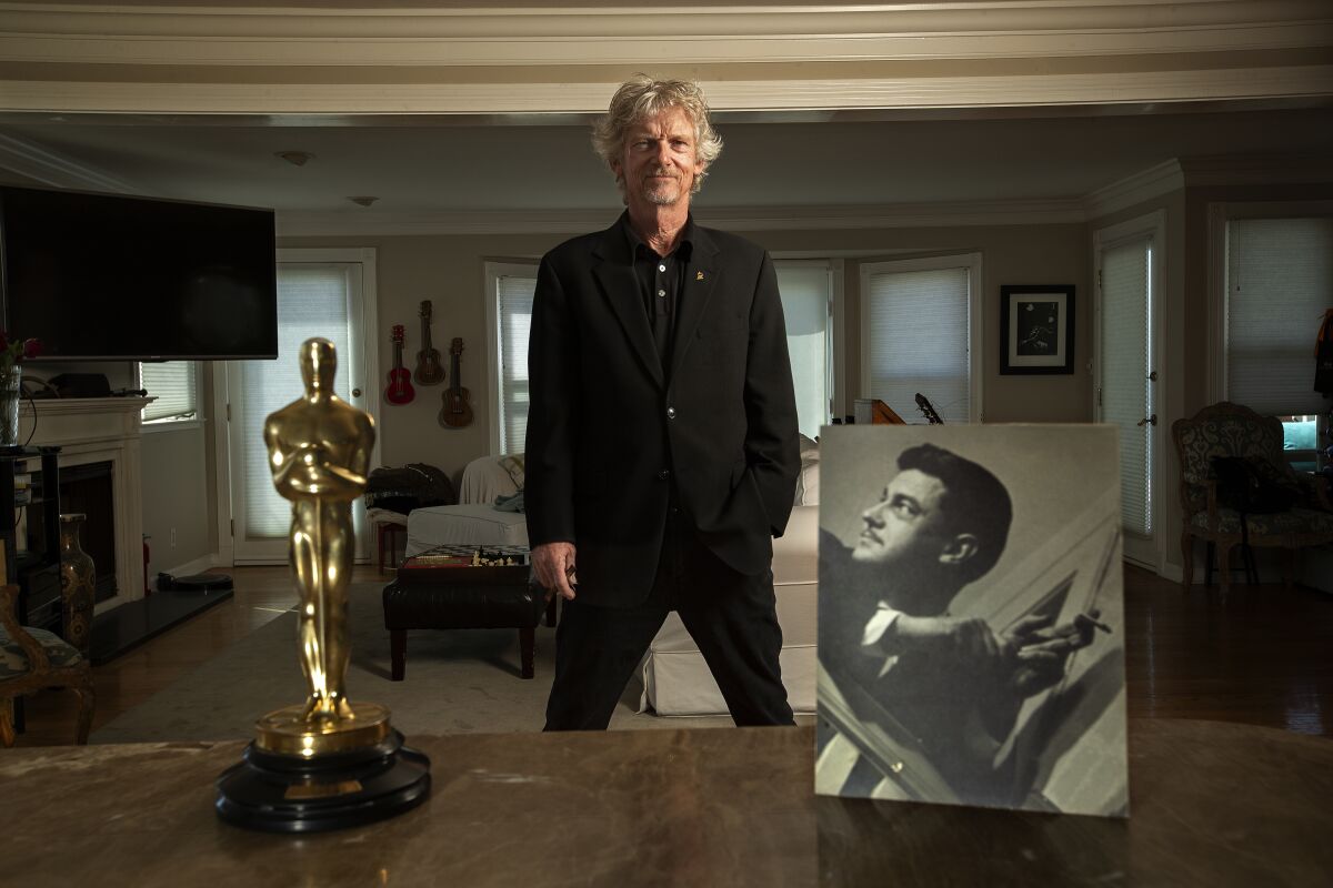 Tom Sturges,  son of legendary writer-director Preston Sturges, is flanked by the Oscar his dad received for original screenplay for the 1940 film "The Great McGinty"  and an image of the man himself. 