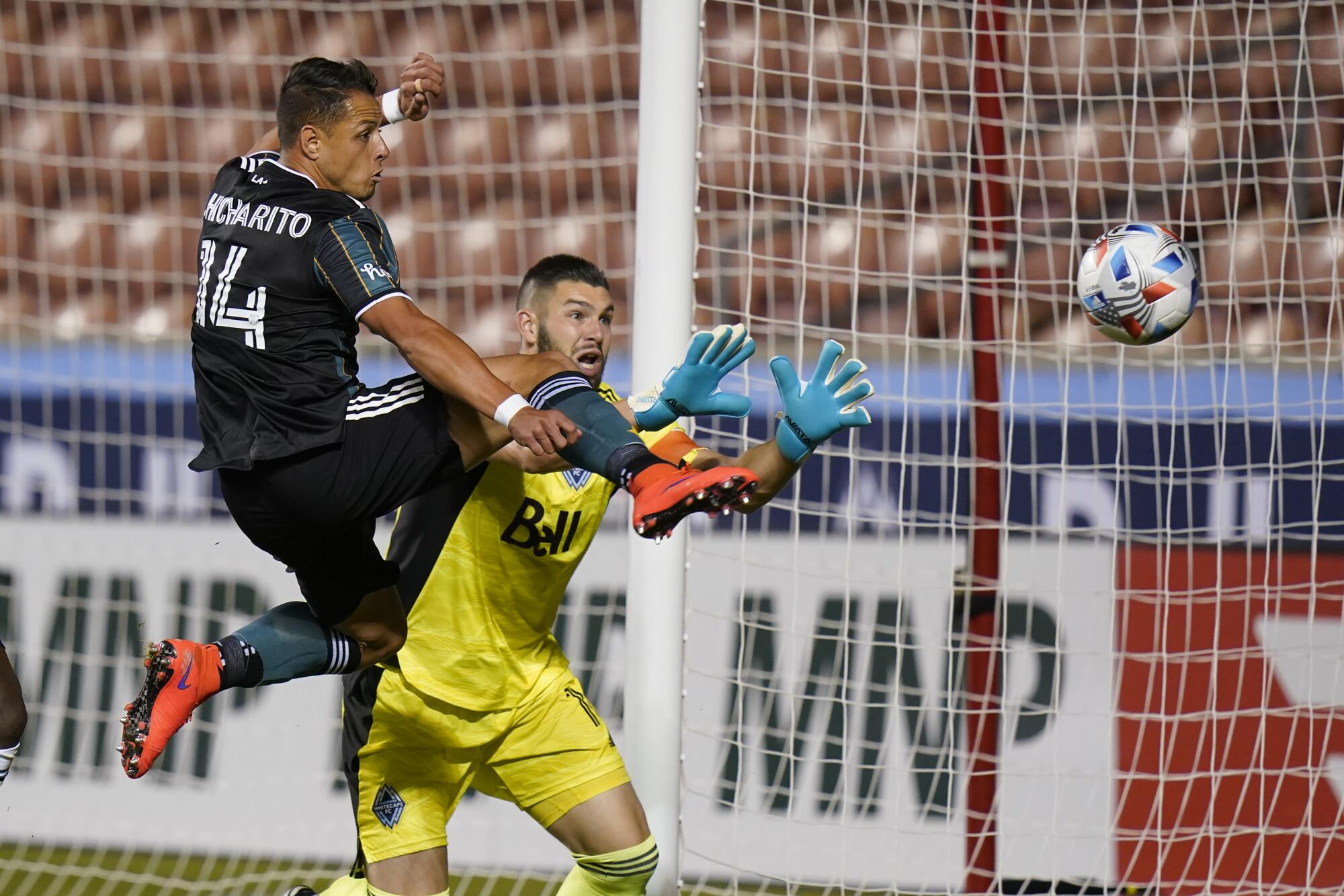 A San Jose goalkeeper defends against a Galaxy player.