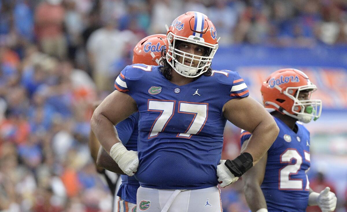 Florida offensive lineman Ethan White (77) stands on the field with his hands on his hips during a game against Alabama