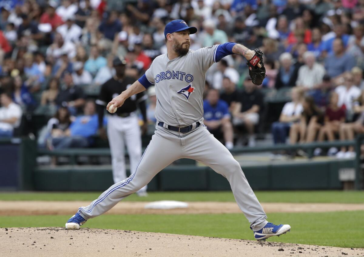 FILE - Toronto Blue Jays starting pitcher John Axford throws against the Chicago White Sox during the first inning of a baseball game in Chicago, in this Saturday, July 28, 2018, file photo. Reliever John Axford’s comeback attempt is taking a detour from Toronto to Milwaukee, where the right-hander started his major league career. Brewers president of baseball operations David Stearns announced Monday, Aug., 2, 2021, the team had acquired the 38-year-old Axford from the Blue Jays for cash considerations. (AP Photo/Nam Y. Huh, File)
