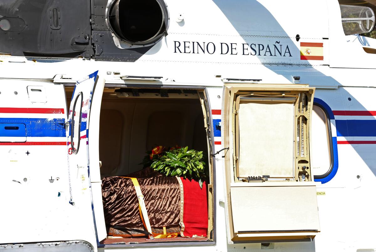 A funeral car heads to Mingorrubio cemetery in El Pardo, Spain, with the coffin of dictator Francisco Franco.