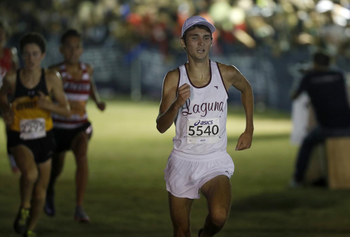 Laguna Beach's Logan Brooks finishes sixth in the Doug Speck's boys' sweepstakes race of the Woodbridge Invitational on Saturday night at SilverLakes Sports Park in Norco.