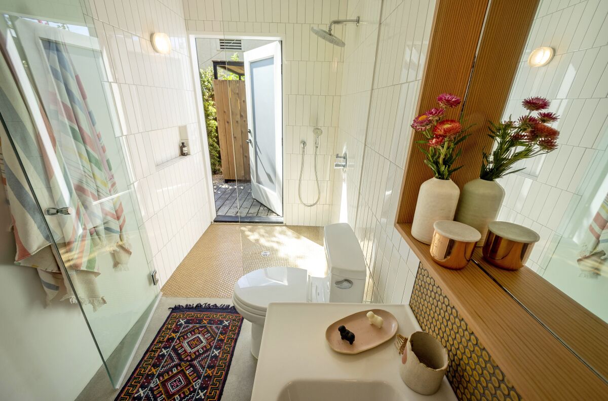 The bathroom door of the ADU opens out to the yard.