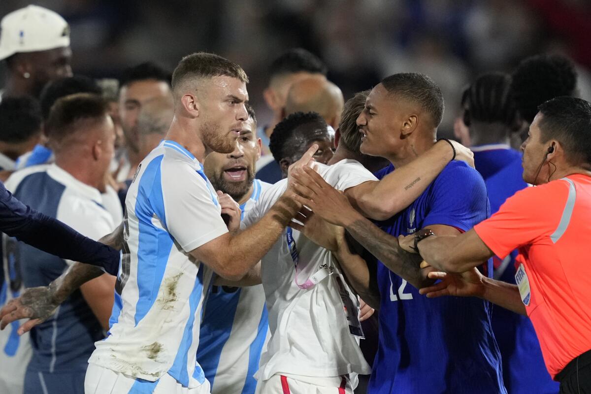 France and Argentina players argue at the end of a quarte final soccer match 