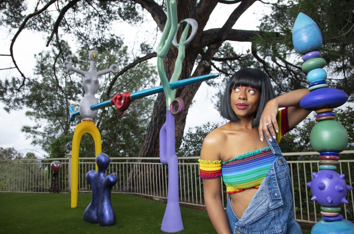 Cashae Monya is also now venturing to Hollywood for roles. Photographed with "The Family," a sculpture at the home of Pam Wagner and Hans Tegebo, on Mount Helix, March 12, 2020 in La Mesa, California. The sculpture is the work of Hans who created it for their backyard.
