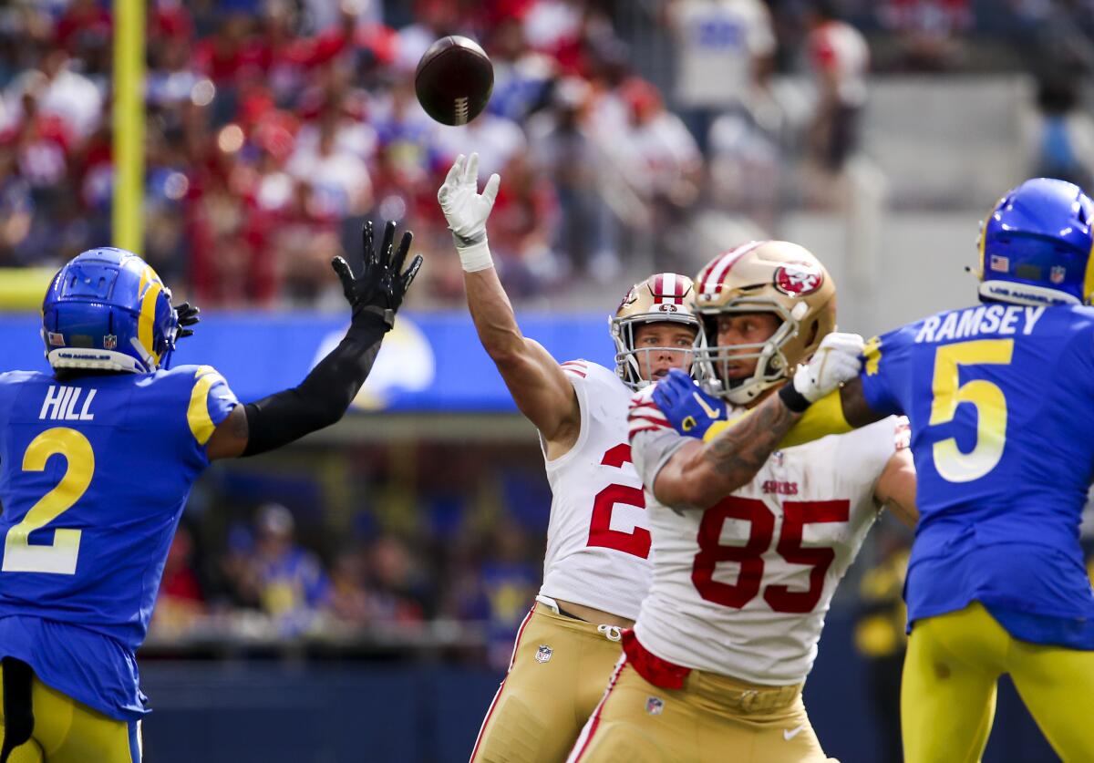 San Francisco's Christian McCaffrey (23) throws pass that turned into a touchdown to Brandon Aiyuk in the second quarter.