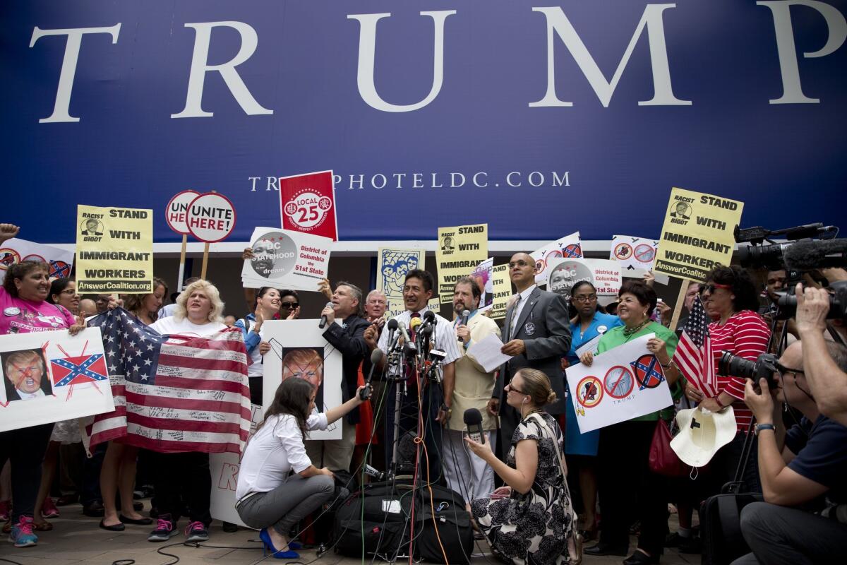 Protesters gather outside the new Trump hotel in Washington on July 9 to protest Republican presidential candidate Donald Trump's comments about Mexican immigrants. A new poll illustrates how deeply polarizing Trump is.
