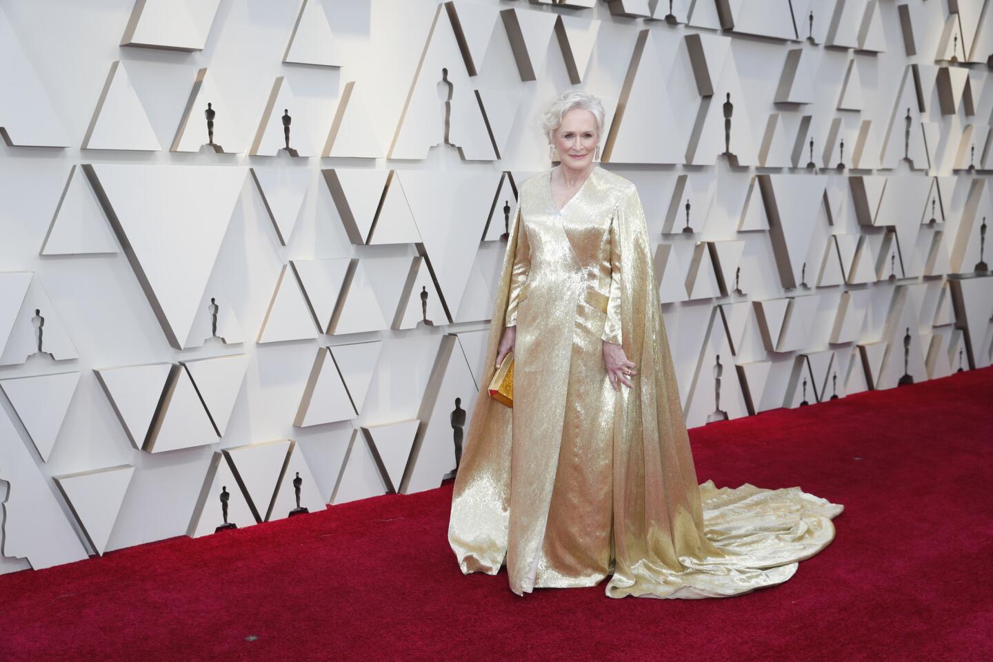 MISS: Glenn Close goes for gold in a 42-pound Carolina Herrera gown with an imperious cape and train but comes up short.