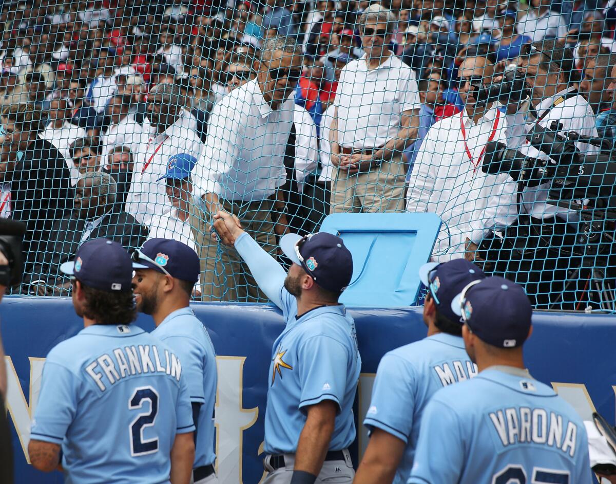 President Obama shakes hands with Tampa Bay Rays players before an exhibition game against the Cuban national team in Havana on Tuesday.