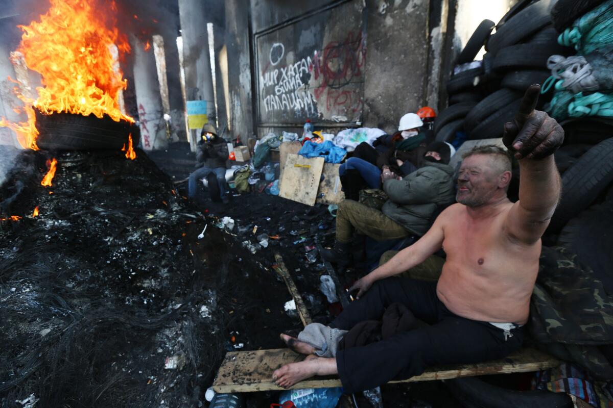 Protesters take a break behind the barricades in central Kiev, Ukraine.