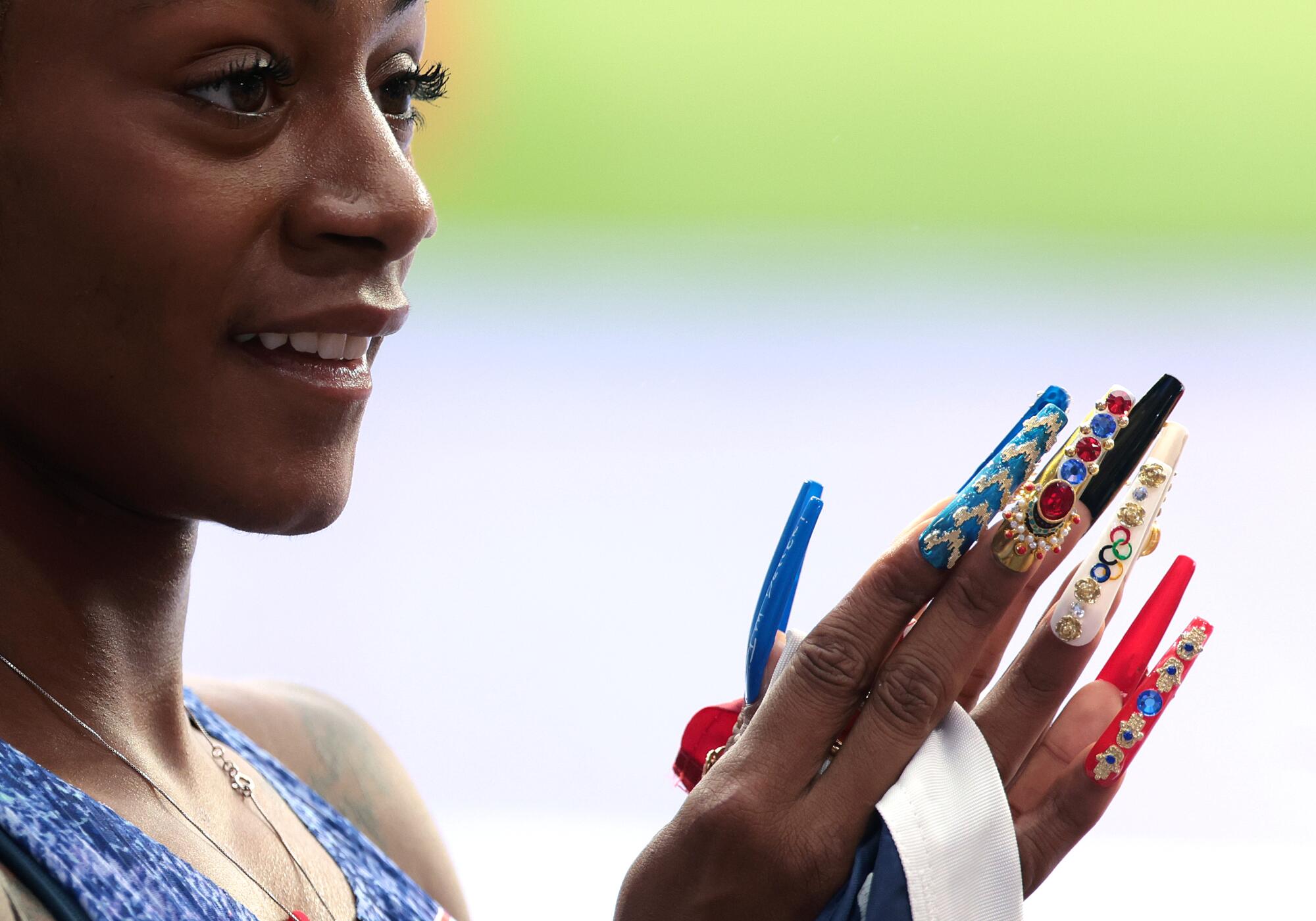 La estadounidense Sha'kari Richardson levanta sus largas uñas tras ganar el viernes la medalla de oro en el relevo 4x100 en los Juegos Olímpicos de París 2024.