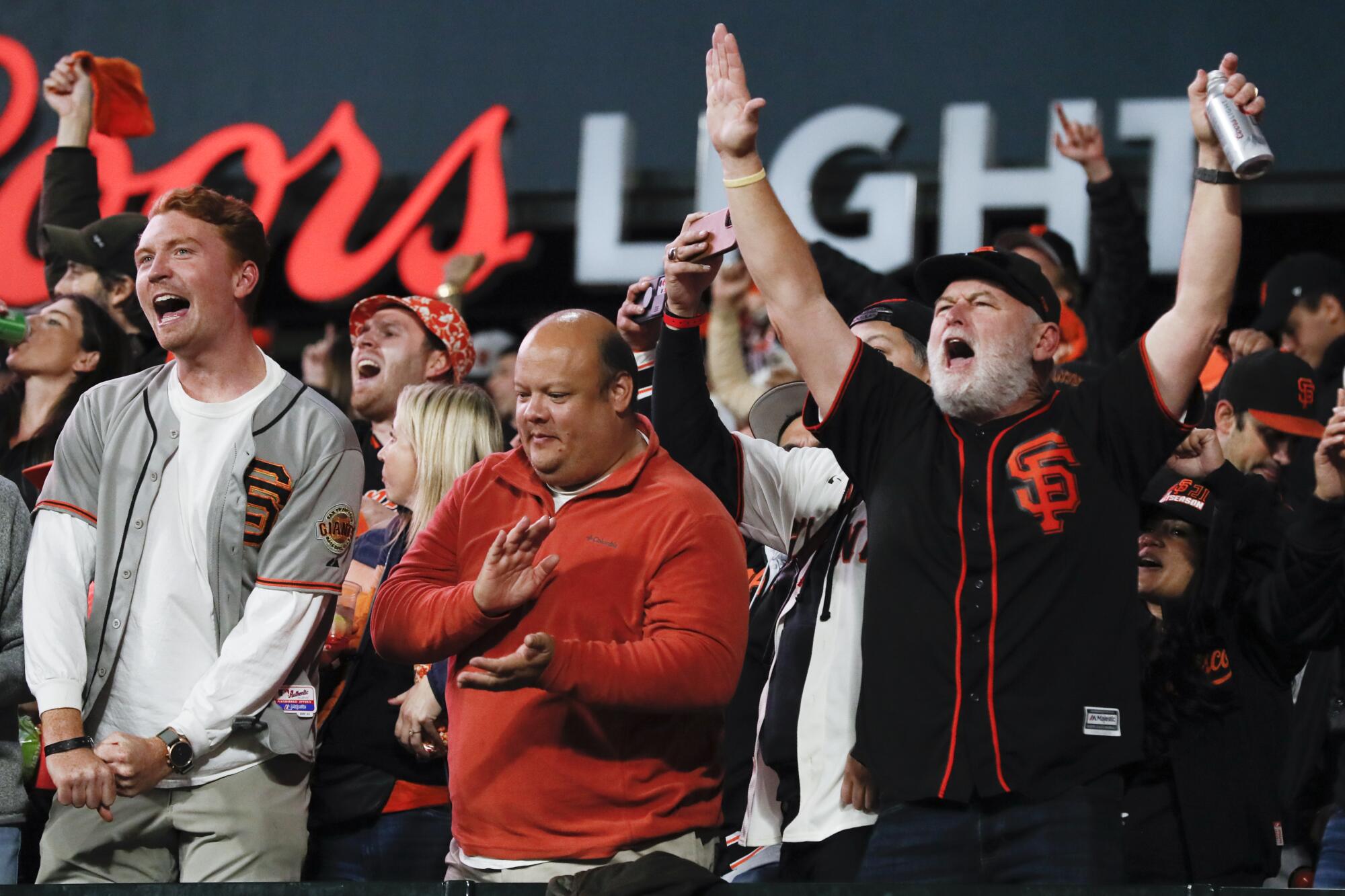 San Francisco Giants fans cheer after a solo home run by Darin Ruf