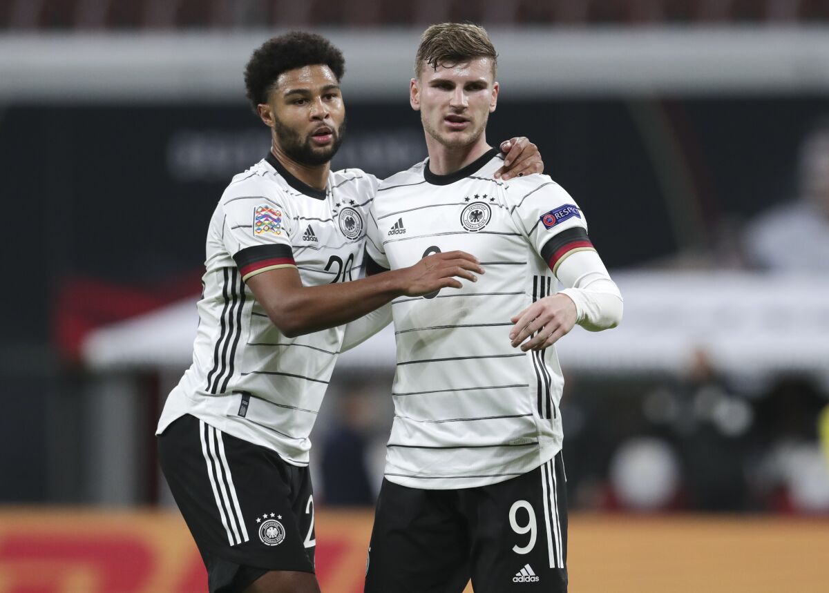 Germany's Timo Werner, right, celebrates with teammate Serge Gnabry after scoring his team's third goal during the UEFA Nations League soccer match between Germany and the Ukraine at the Red Bull Arena in Leipzig, Germany, Saturday, Nov. 14, 2020. (AP Photo/Michael Sohn)