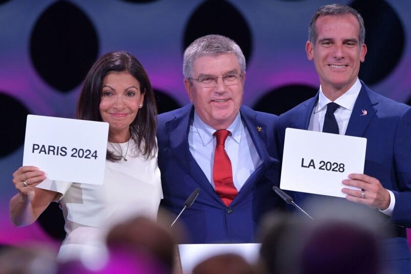 International Olympic Committee (IOC) President Thomas Bach (C) poses for pictures with Paris Mayor Anne Hidalgo (L) and Los Angeles Mayor Eric Garcetti during the 131st IOC session in Lima on September 13, 2017. The ICO meeting in Lima will confirm Paris and Los Angeles as hosts for the 2024 and 2028 Olympics, crowning two cities at the same time in a historic first for the embattled sports body. / AFP PHOTO / Fabrice COFFRINIFABRICE COFFRINI/AFP/Getty Images ** OUTS - ELSENT, FPG, CM - OUTS * NM, PH, VA if sourced by CT, LA or MoD **