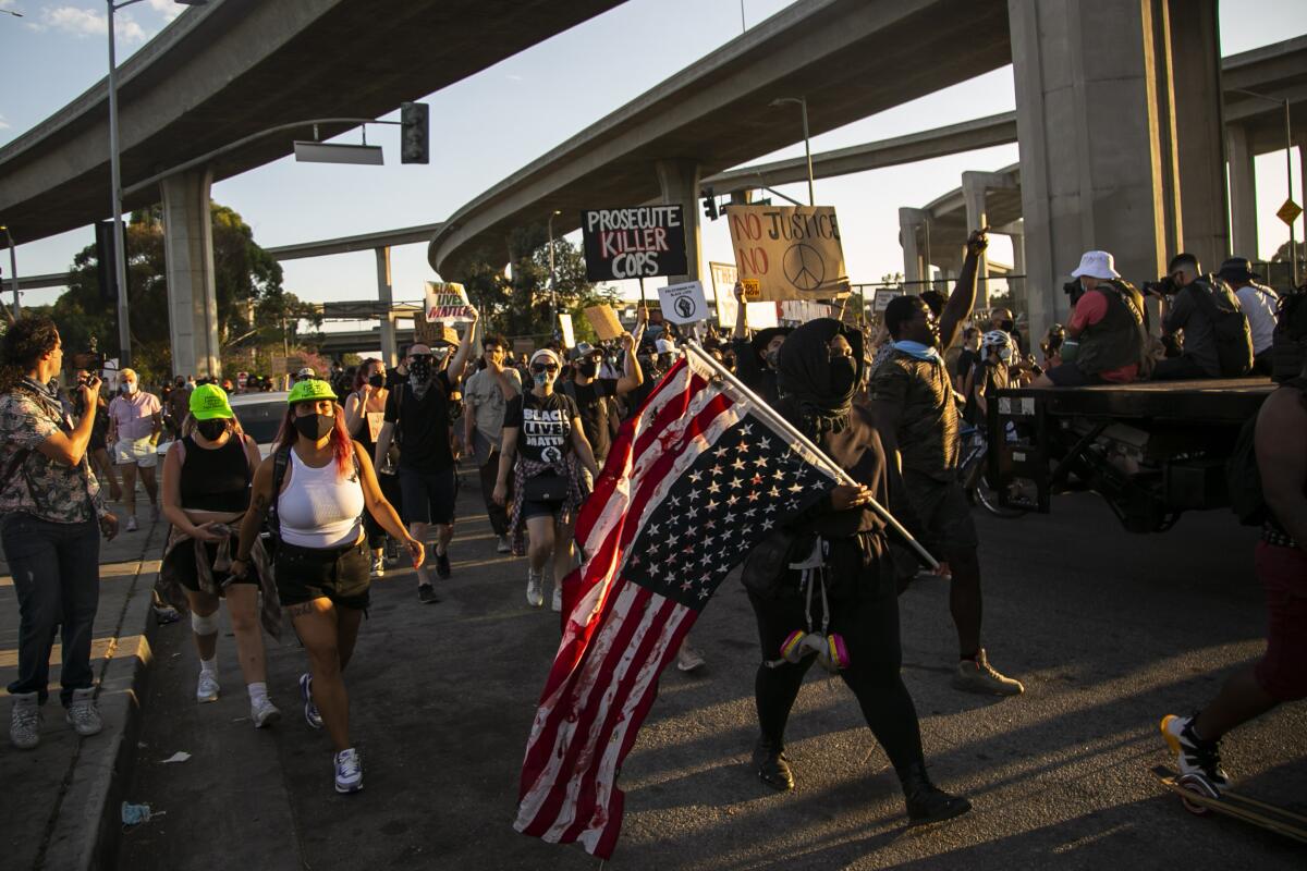 People on a freeway ramp during a protest over the killing of Dijon Kizzee.