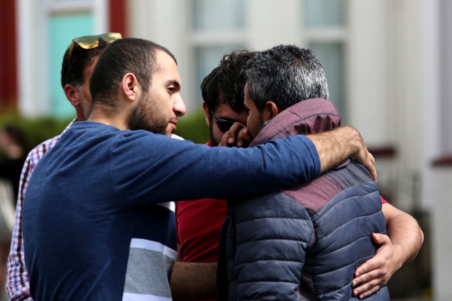 Men gather after laying flowers for the victims outside one of the Christchurch mosques.
