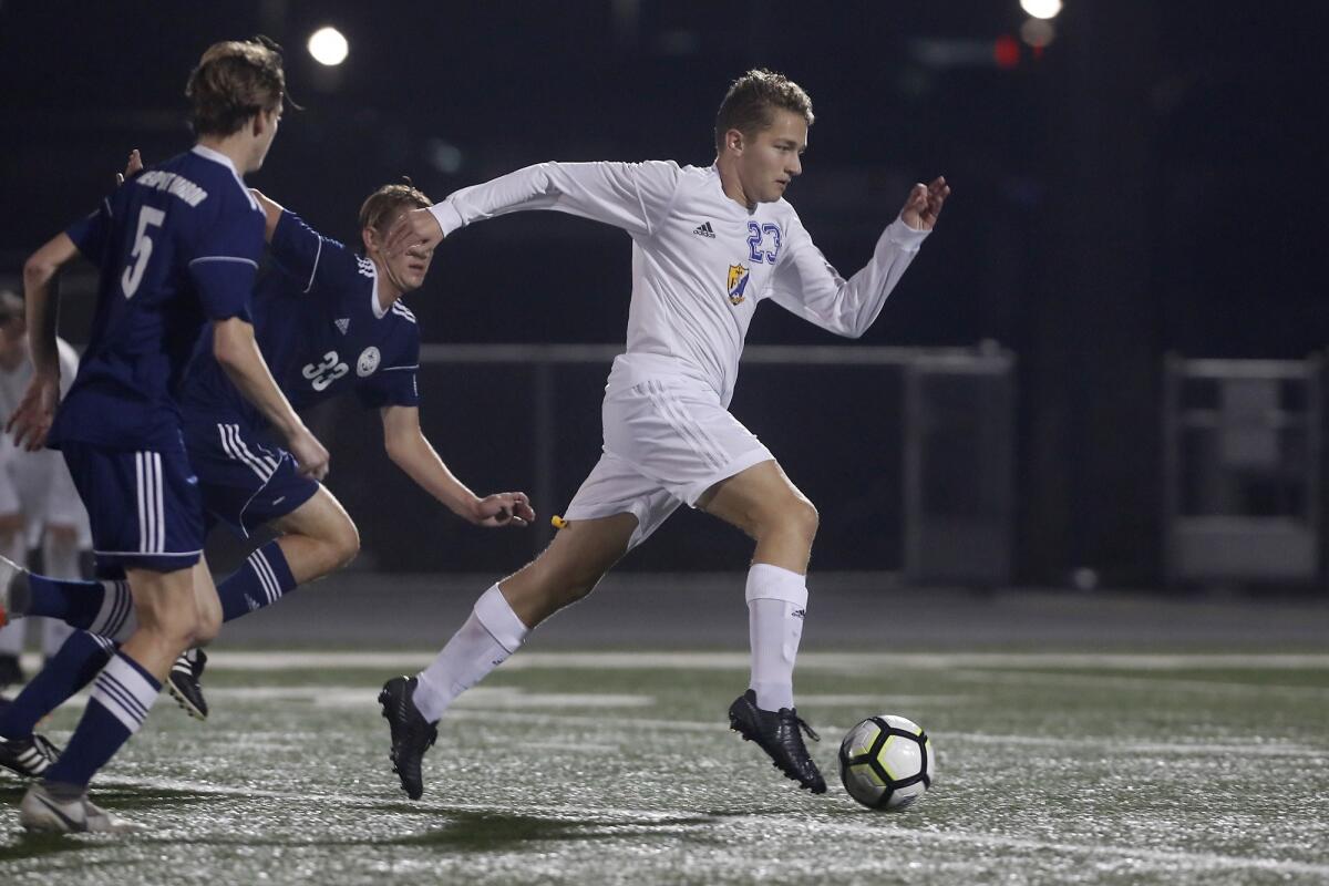 Fountain Valley High's Sebastian Rus, pictured advancing the ball at Newport Harbor on Dec. 19, 2018, scored the Barons' only goal in a 4-1 loss at Long Beach Cabrillo Wednesday.