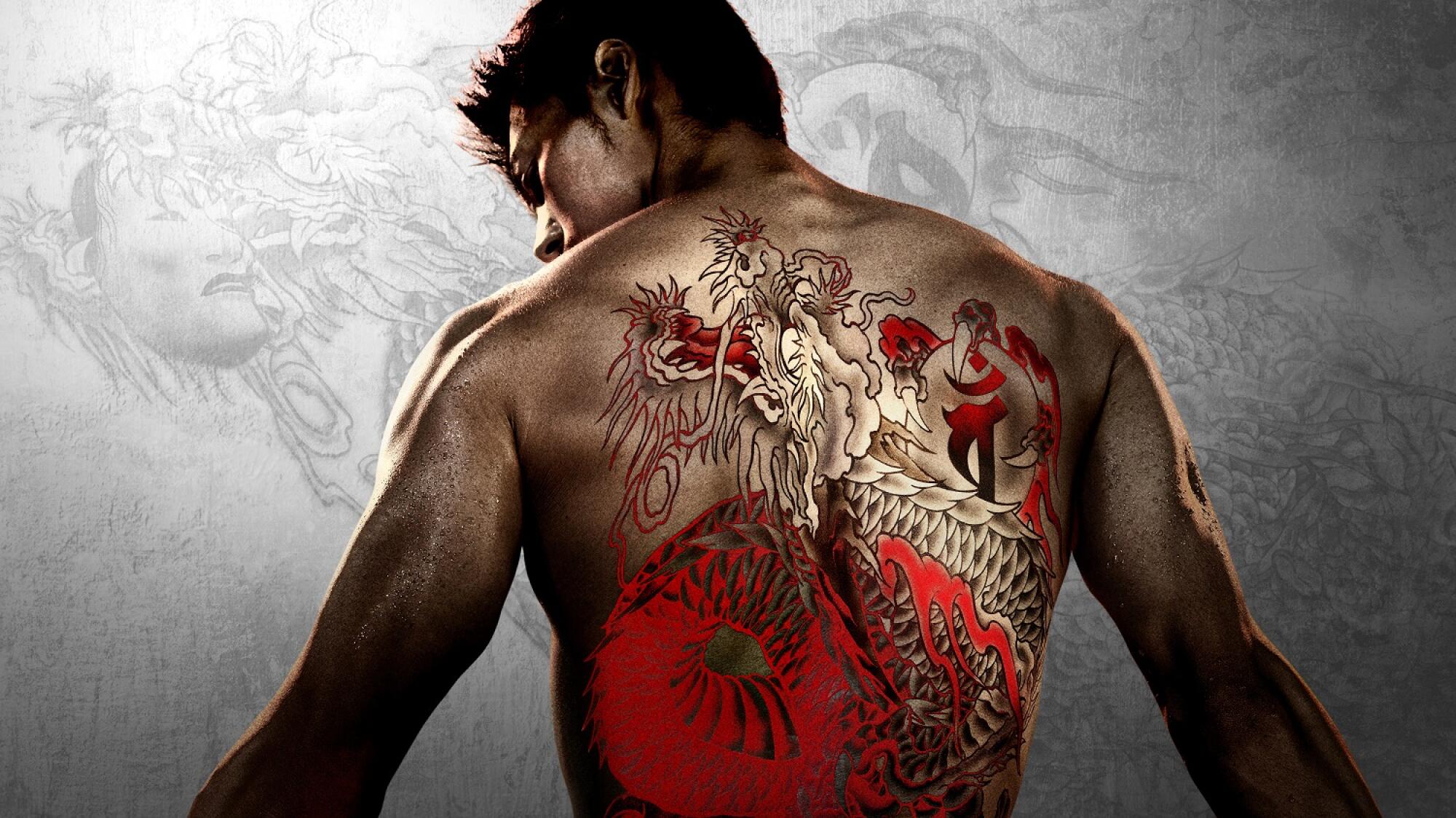 The back of a man with a large, red dragon tattoo.