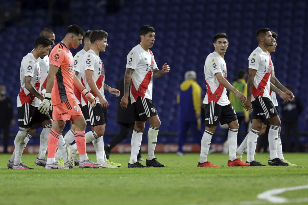 River Plate players walk off the field at the first half of a local league soccer match against Boca Juniors at the Bombonera stadium in Buenos Aires, Argentina, Sunday, May 16, 2021. (AP Photo/Daniel Jayo)