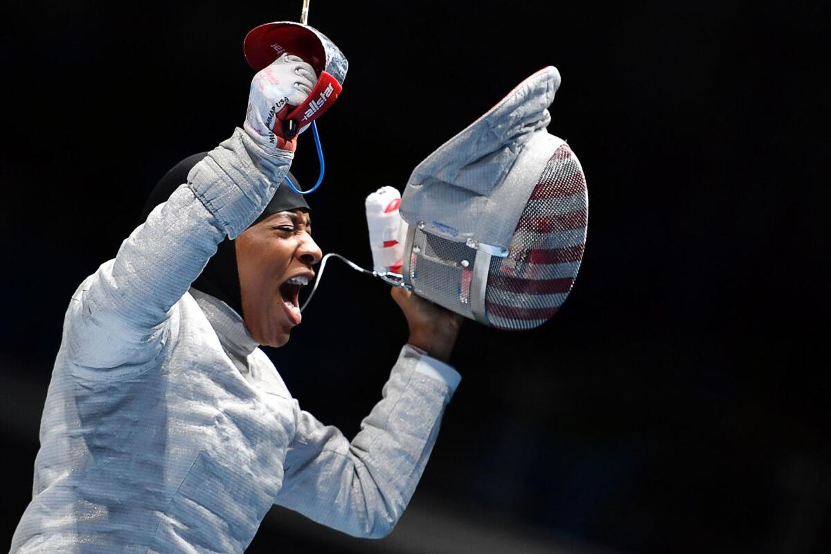 Ibtihaj Muhammad of the U.S. celebrates her win over Ukraine's Olena Kravatska.