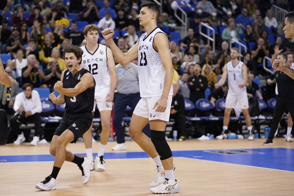 Long Beach State outside hitter Alex Nikolov and libero Mason Briggs celebrate a point against UCLA.