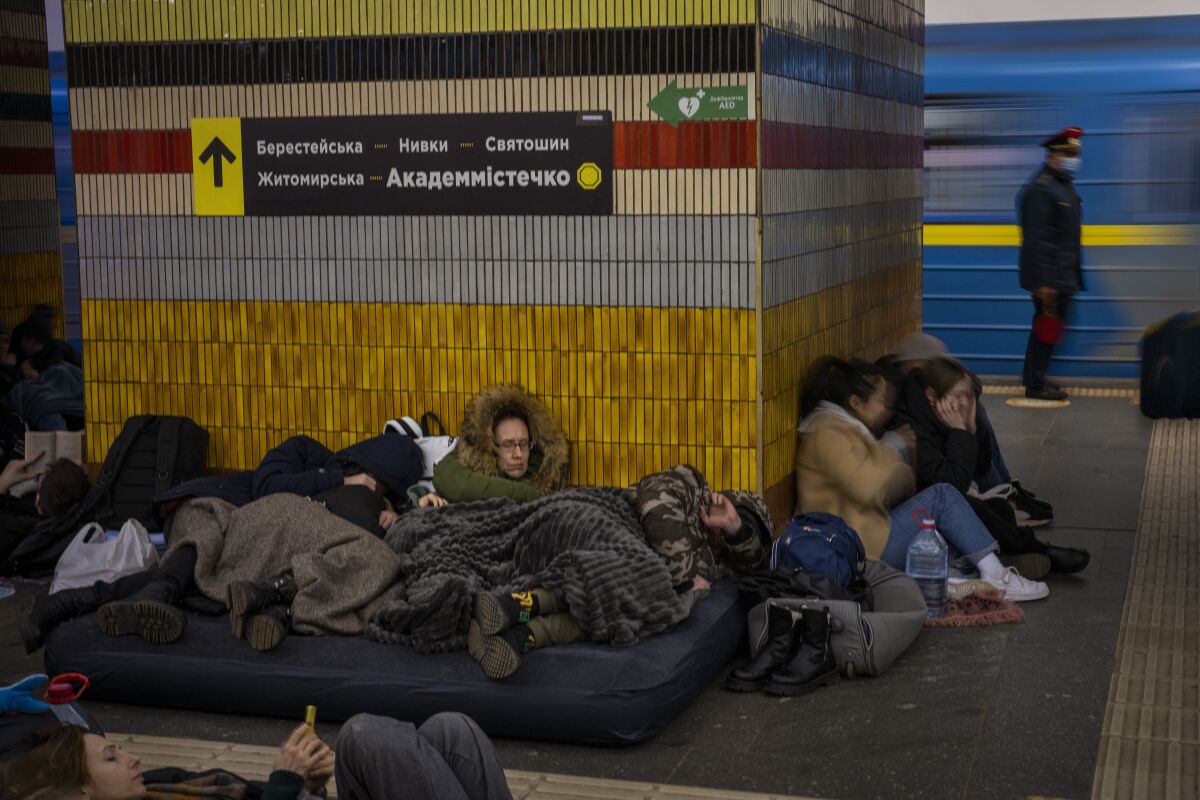 People sleep in the Kyiv subway.