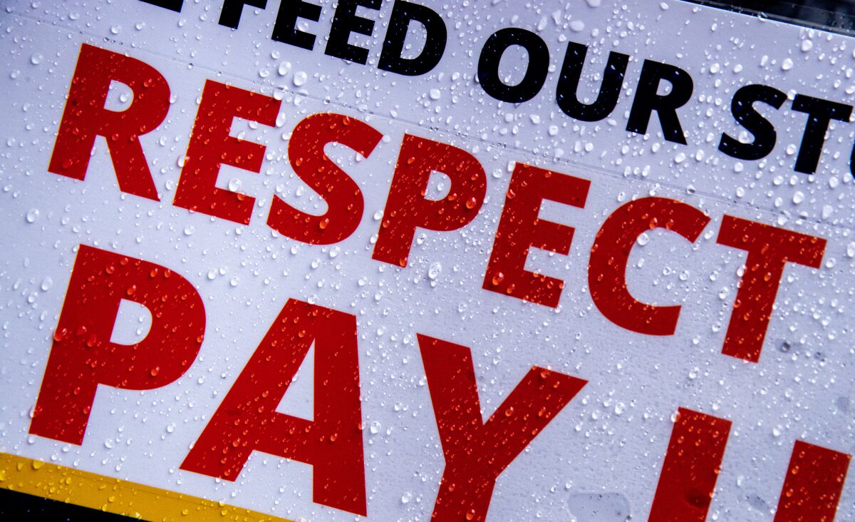 Raindrops cover a sign that partially reads "Respect, Pay."