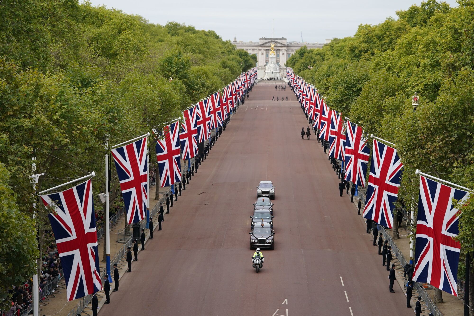 A motorcade drives the Mall in London.