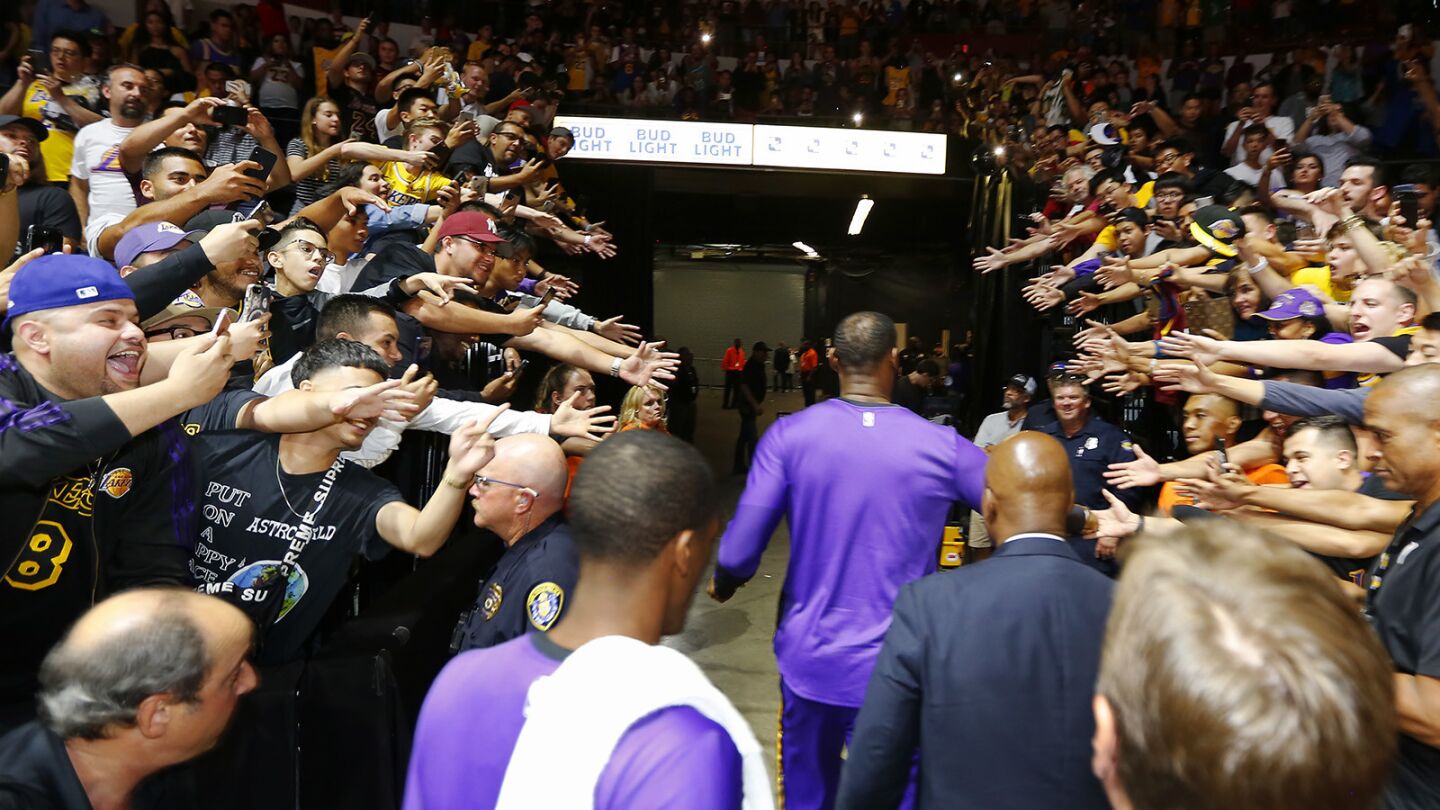 Los Angeles Lakers LeBron James walks off the court though fans after a game against the Denver Nuggets in San Diego on Sunday, September 30, 2018. (Photo by K.C. Alfred/San Diego Union-Tribune)