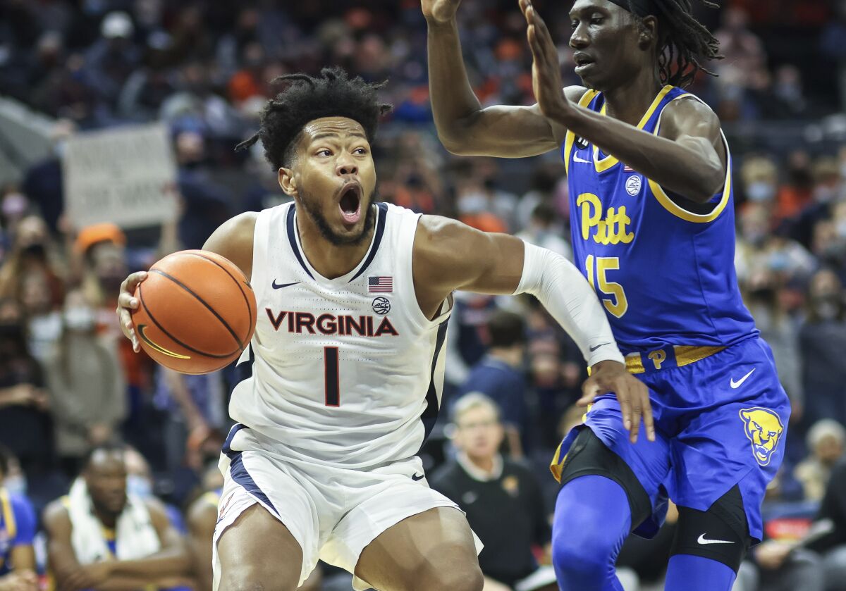 Virginia forward Jayden Gardner (1) moves around Pittsburgh forward Mouhamadou Gueye (15) during an NCAA college basketball game in Charlottesville, Va., Friday, Dec. 3, 2021. (AP Photo/Andrew Shurtleff)