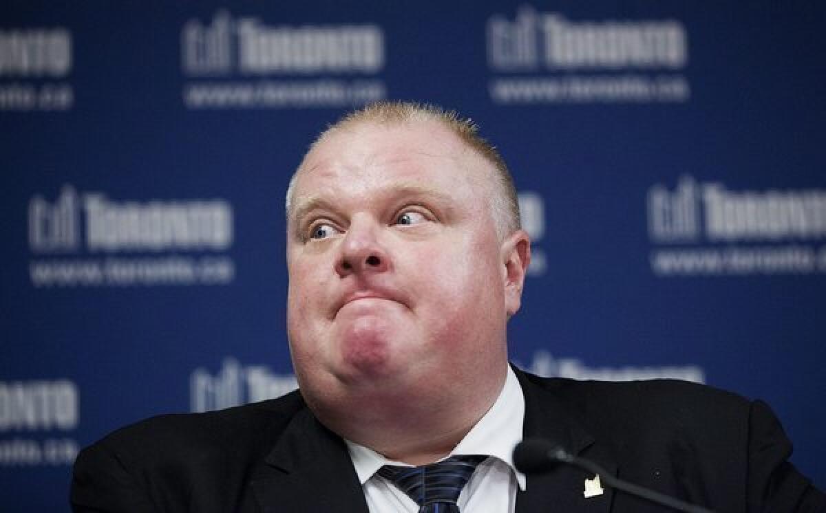 Toronto Mayor Rob Ford answers questions about staff changes at at city hall during a news conference Friday.