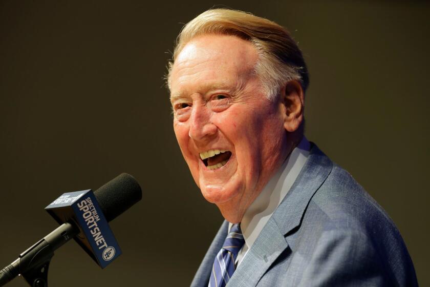 FILE - In this Sept. 24, 2016, file photo, Los Angeles Dodgers and Hall of Fame broadcaster Vin Scully smiles as he answers questions during a news conference at Dodger Stadium in Los Angeles. Scully will receive the Presidential Medal of Freedom on Tuesday at the White House. Scully is one of 21 recipients of the Medal of Freedom announced Wednesday, Nov. 16, 2016, including NBA Hall of Famers Kareem Abdul-Jabbar and Michael Jordan. (AP Photo/Jae C. Hong, File)