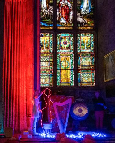 Stained glass windows glow in the Shatto Chapel at the First Congregational Church.