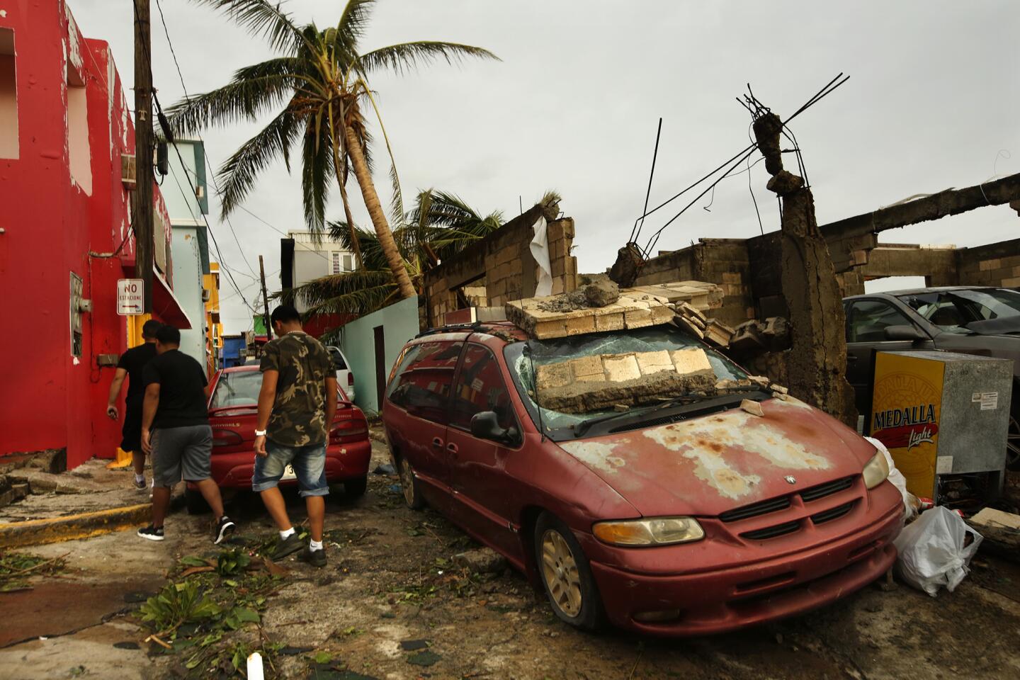 The day after Hurricane Maria's direct hit, residents of La Perla, part of Old San Juan, begin cleaning up.