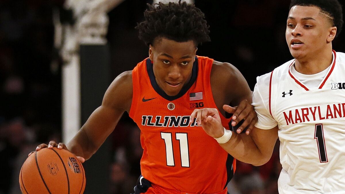 Illinois guard Ayo Dosunmu (11) brings the ball up court against Maryland guard Anthony Cowan Jr. during the second half Saturday.