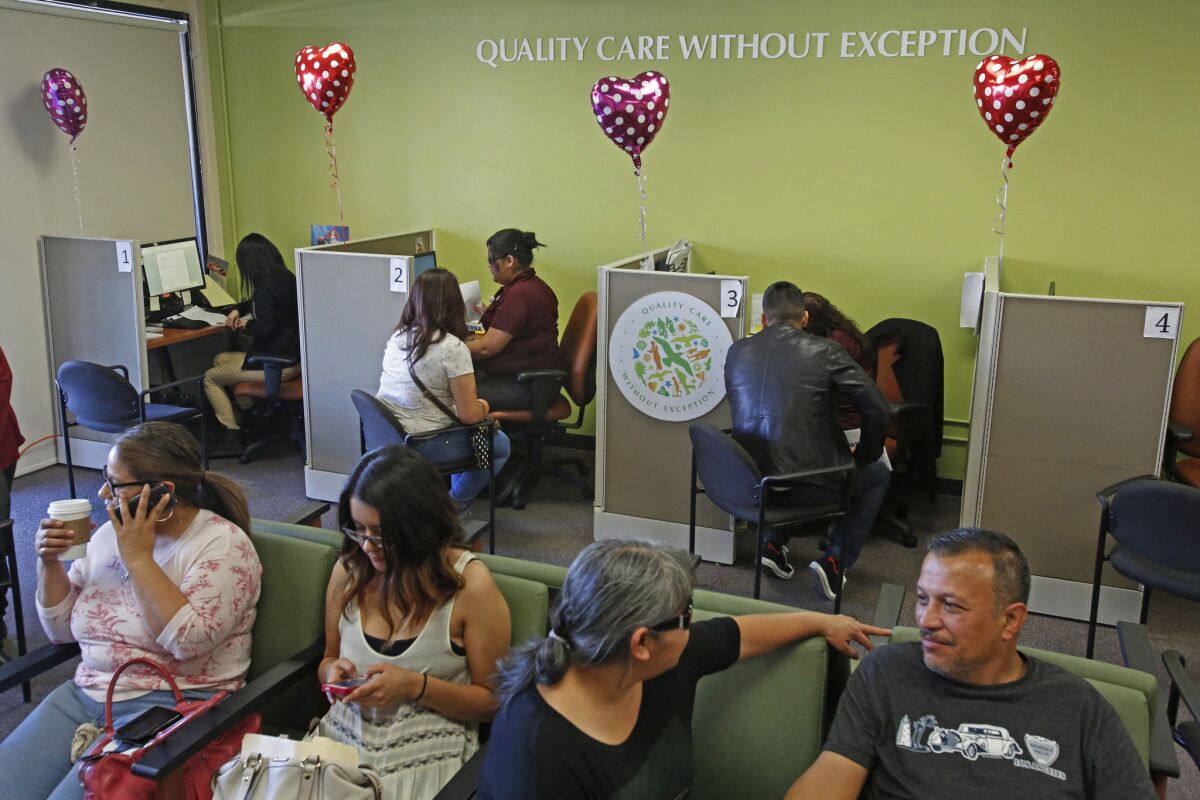 People sign up for Obamacare at AltMed Health Services in Los Angeles earlier this year.