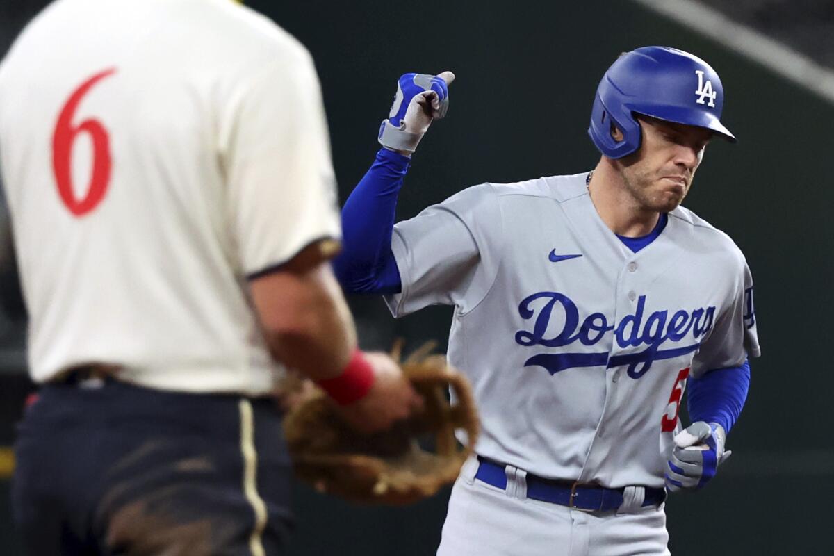 Dodgers beat Texas 11-5 in return to Globe Life Field