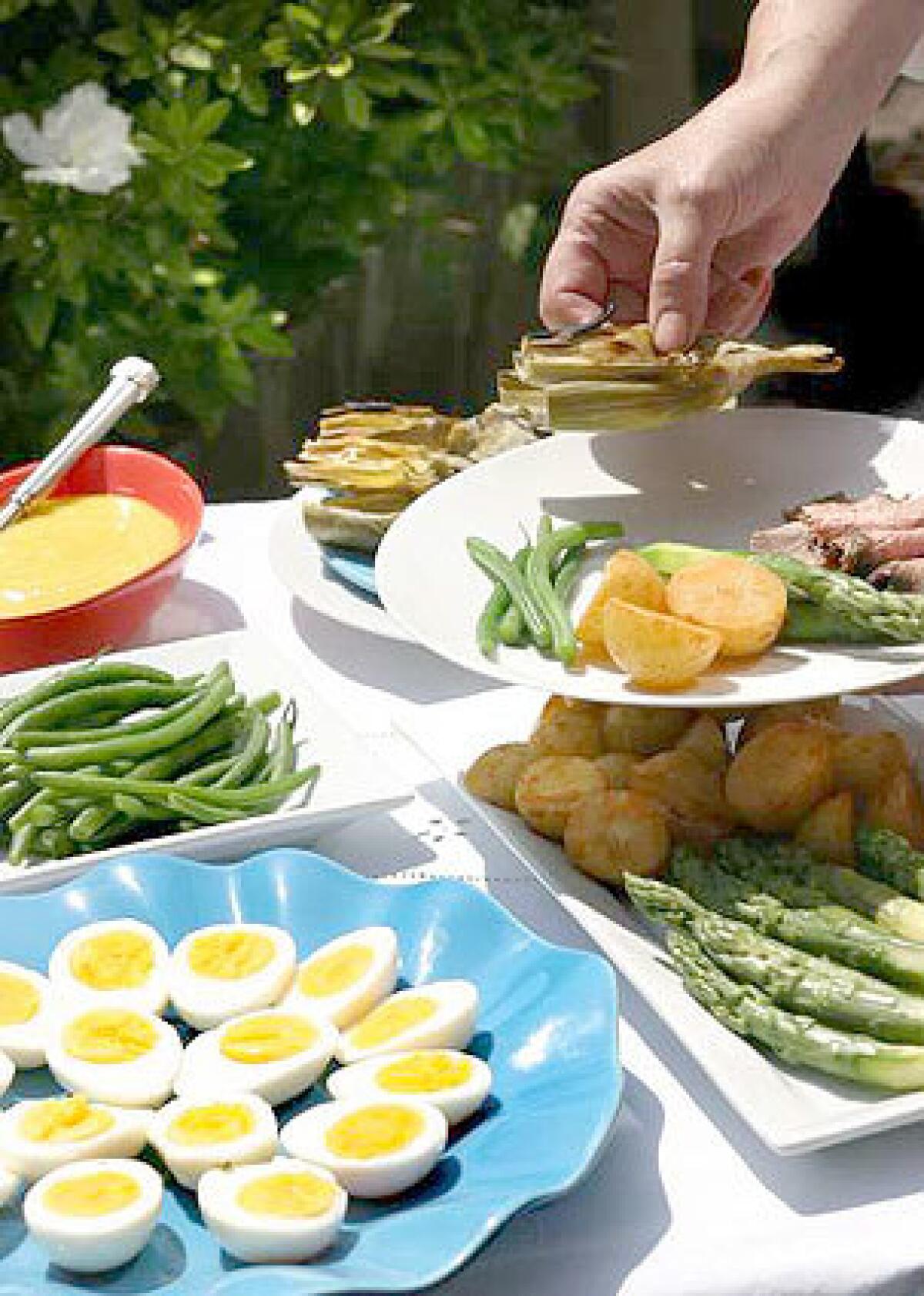 BIG FLAVOR: Aioli rocks with grilled artichokes, hard-boiled eggs, beans and asparagus.