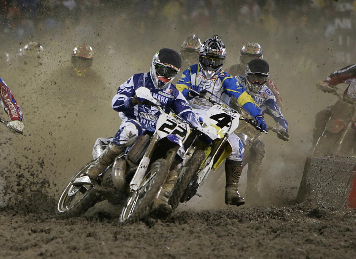 Chad Reed (22) cuts in front of Ricky Carmichael during a Supercross series race in 2005.