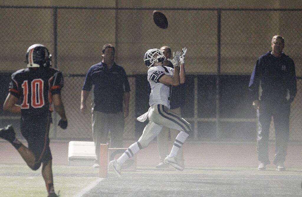 Newport Harbor's Quest Truxton makes a catch for a touchdown during a game against Huntington Beach on Friday.