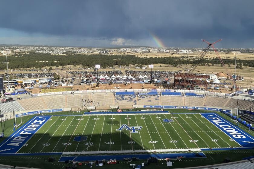 A rainbow appears beyond Falcon Stadium less than an hour after lightning delayed warmups for SDSU's game at Air Force.