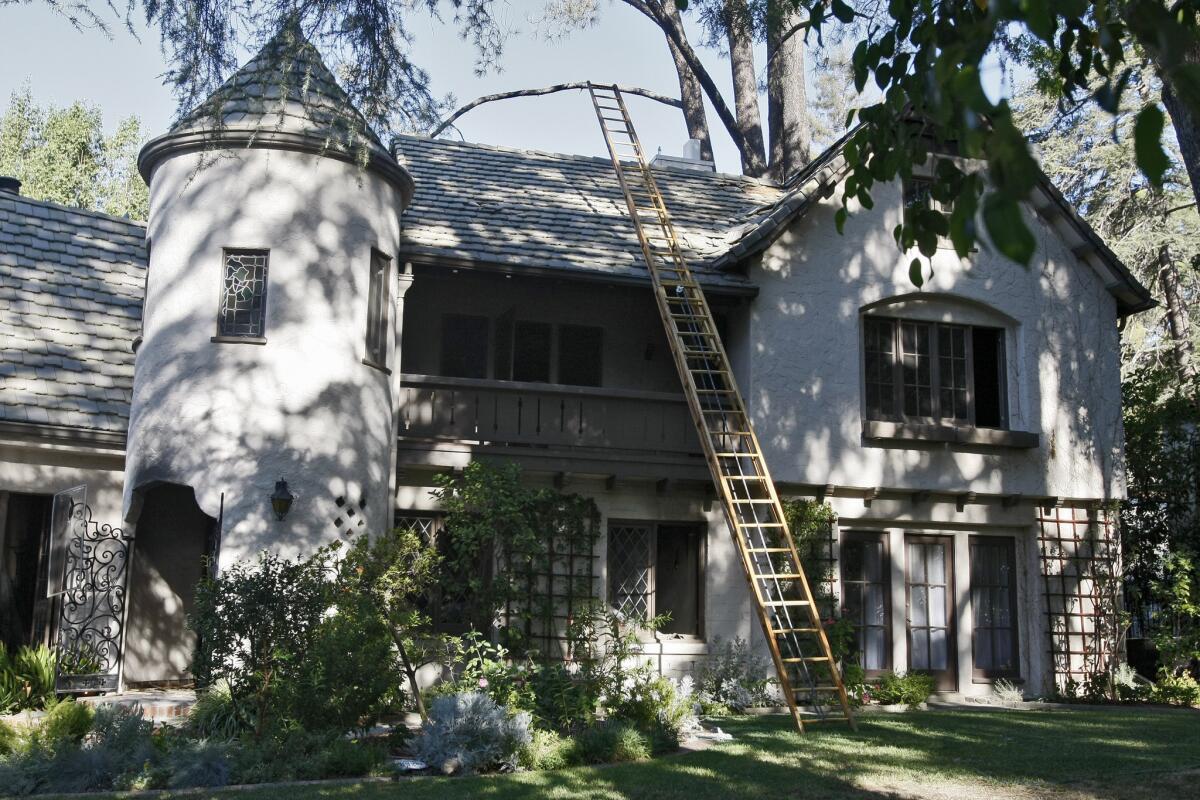 A home at 5147 Jarvis Ave. that sustained extensive fire damage the evening before, still has a ladder leading to the roof in La Cañada Flintridge on the morning of Thursday, Sept. 11, 2014.