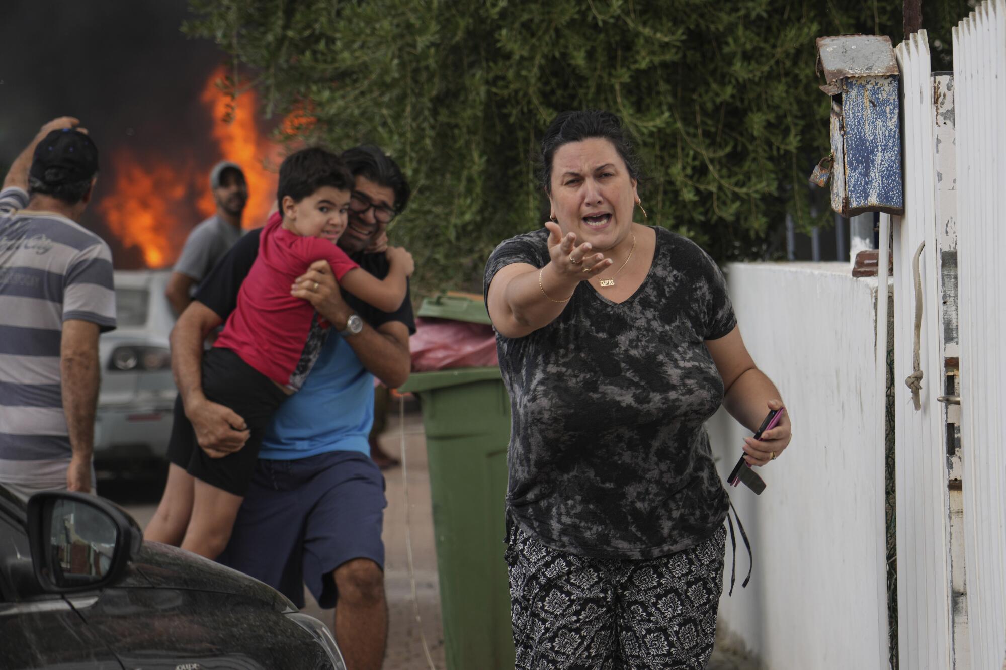 Israelis evacuating a site struck by a rocket fired from the Gaza Strip