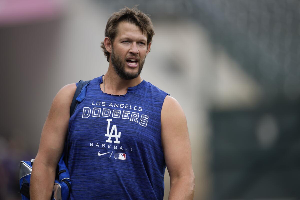 Dodgers starting pitcher Clayton Kershaw stands on the field.