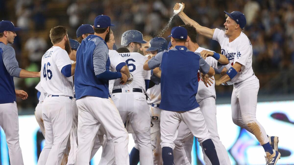 The Dodgers celebrate Thursday's victory over Arizona.