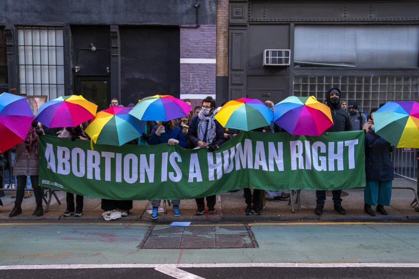 NEW YORK, NY - FEBRUARY 3: Abortion rights activists hold banners and umbrellas to block anti-abortion advocates across from the Planned Parenthood clinic on February 3, 2024 in New York City. The protests, which are up the road from the Basilica of St. Patrick's Old Cathedral, have been occurring monthly outside of the church and clinic for years and are where a number of anti-abortion activists worship. The protests have been given added urgency by the Supreme Court ruling against Roe v. Wade. A woman's right to choose is expected to be a major campaign issue in the 2024 presidential election.(Photo by Robert Nickelsberg/Getty Images)